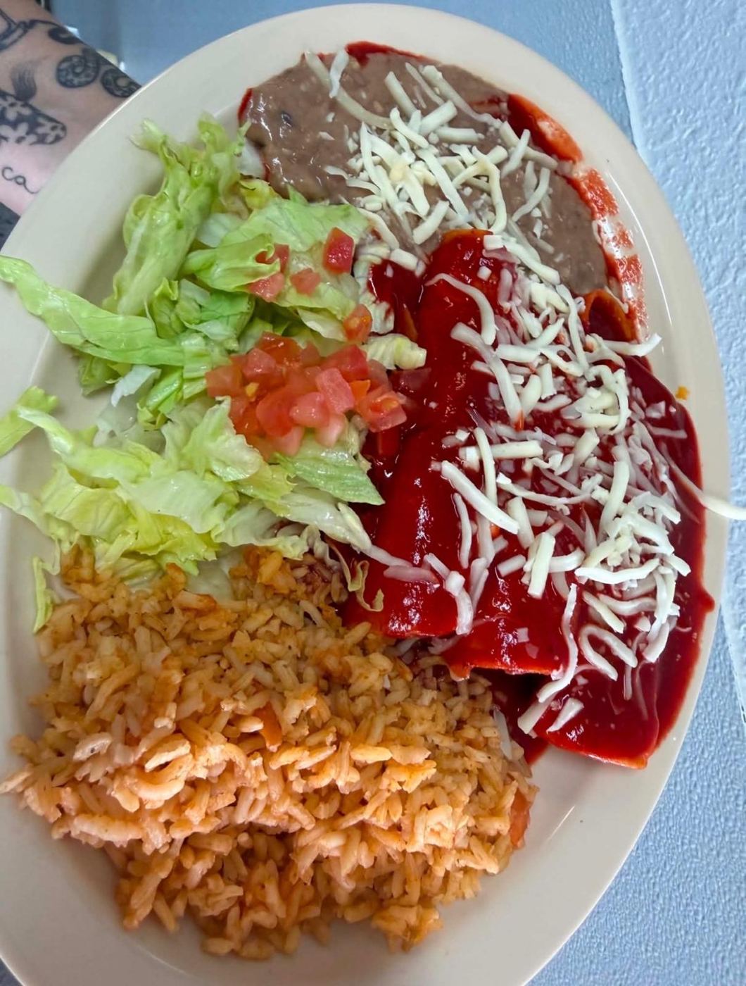 Red cheese enchiladas plate with Mexican rice, beans and salad at Maribu's Mexican Restaurant, El Paso TX