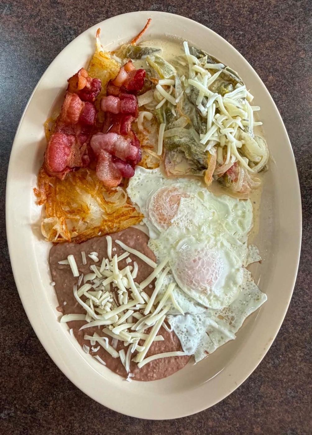 Breakfast plate with rajas con queso, eggs, bacon, hash browns and refried beans at Maribu's on Edgemere Blvd, El Paso