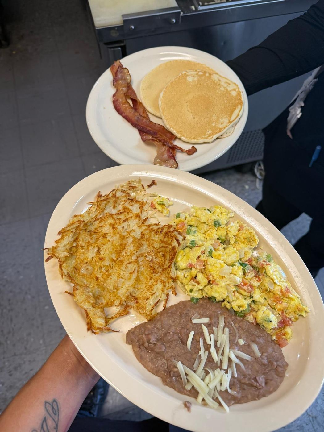 Huevos a la mexicana with hash browns, refried beans, pancakes and bacon at Maribu's in far east El Paso, Texas