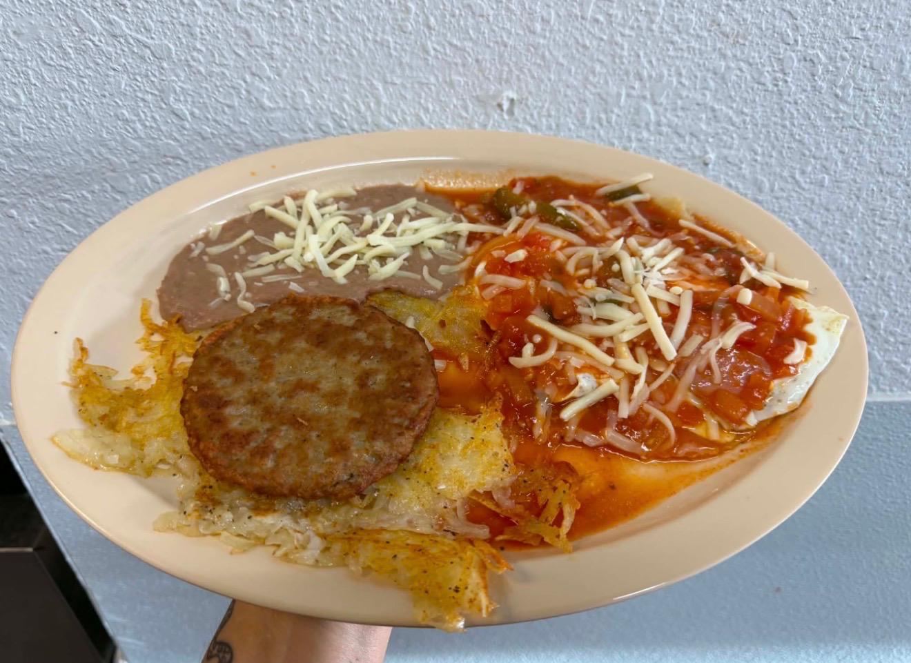 Huevos rancheros with sausage, hash browns and refried beans at Maribu's in far east El Paso, TX